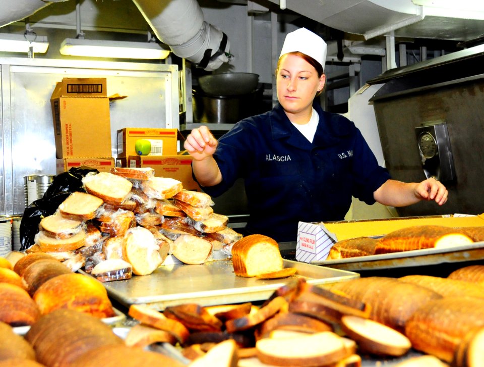 US Navy 100223-N-7939W-016 Aviation Ordnanceman Seaman Megan Alascia wraps fresh baked bread in the galley of the aircraft carrier USS Nimitz (CVN 68)