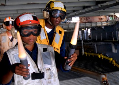 US Navy 100223-N-2000D-105 Boatswain's Mate 3rd Class Viviana Milos, from the Dominican Republic, as she directs an air-cushioned landing craft (LCAC) into the well deck of the amphibious dock landing ship USS Carter Hall (LSD photo