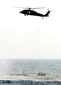 US Navy 100222-N-7058E-182 An MH-60S Sea Hawk helicopter assigned to Helicopter Sea Combat Squadron (HSC) 22 hovers over the position of illicit drugs dumped overboard by the crew of a high-speed