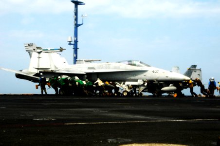 US Navy 100227-N-3038W-346 Flight deck personnel push back an F-A-18C Hornet aboard USS Nimitz (CVN 68)