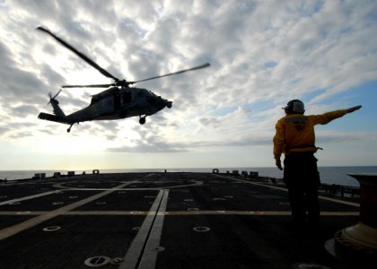 US Navy 100224-N-7058E-138 Aviation Electrician's Mate 3rd Class David Harden launches a MH-60S Sea Hawk helicopter assigned to Helicopter Sea Combat Squadron (HSC) 22 from the littoral combat ship USS Freedom (LCS 1)