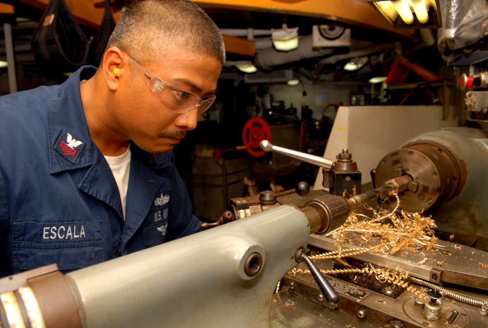 US Navy 100227-N-6692A-031 Machinery Repairman 1st Class Julius M. Escala, from Honolulu, Hawaii, makes a valve fitting aboard the amphibious dock landing ship USS Harpers Ferry (LSD 49)