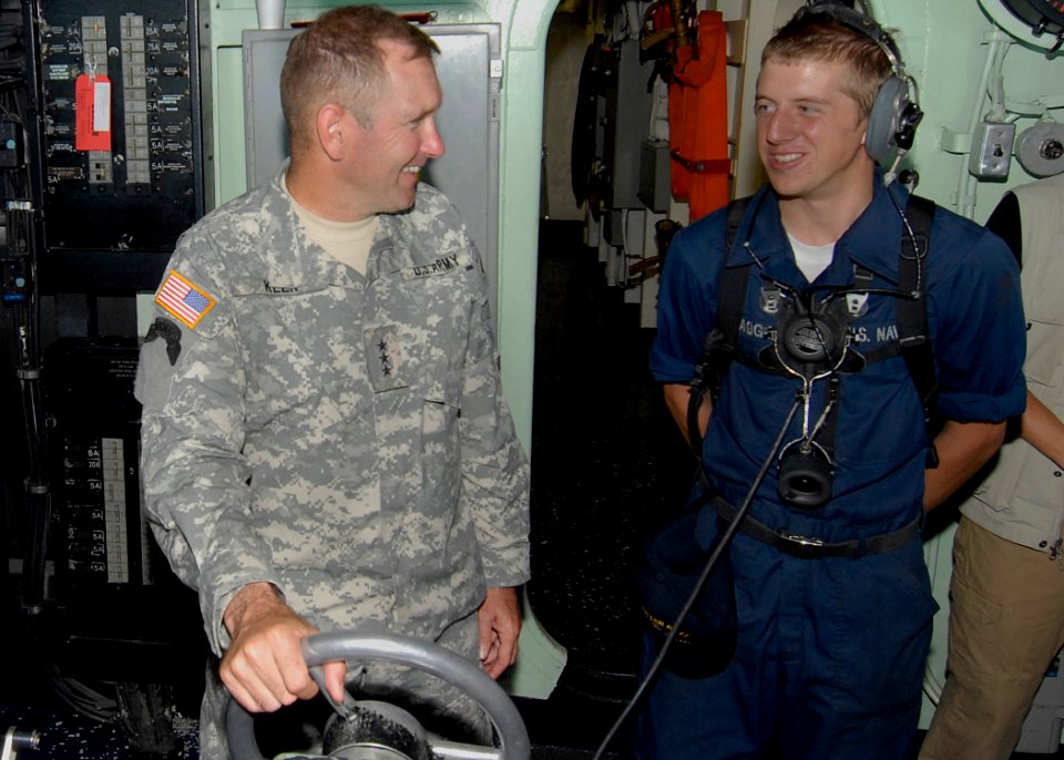 US Navy 100228-N-2000D-162 Lt. Gen. P.K. (Ken) Keen, commander of Joint Task Force Haiti, talks with Seaman Andrew Plagge, from Fort Dodge, Iowa, in the pilothouse of the amphibious dock landing ship USS Carter Hall (LSD 50)