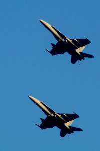 US Navy 100228-N-3038W-163 F-A-18C Hornet strike fighters assigned to the Sidewinders of Strike Fighter Squadron (VFA) 86, pass above the aircraft carrier USS Nimitz (CVN 68)