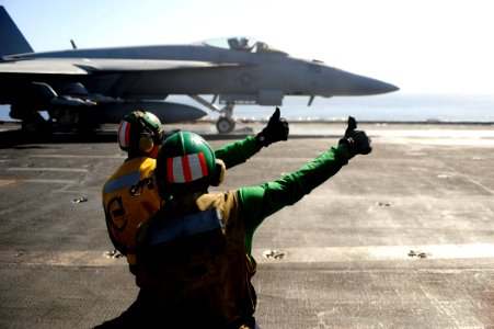US Navy 100223-N-6604E-112 Aviation's Boatswain's Mate (Equipment) 2nd Class Derrick Delhomme and Aviation Boatswain's Mate (Equipment) 2nd Class Kenneth London give a thumbs up to launch an F-A-18F Super Hornet