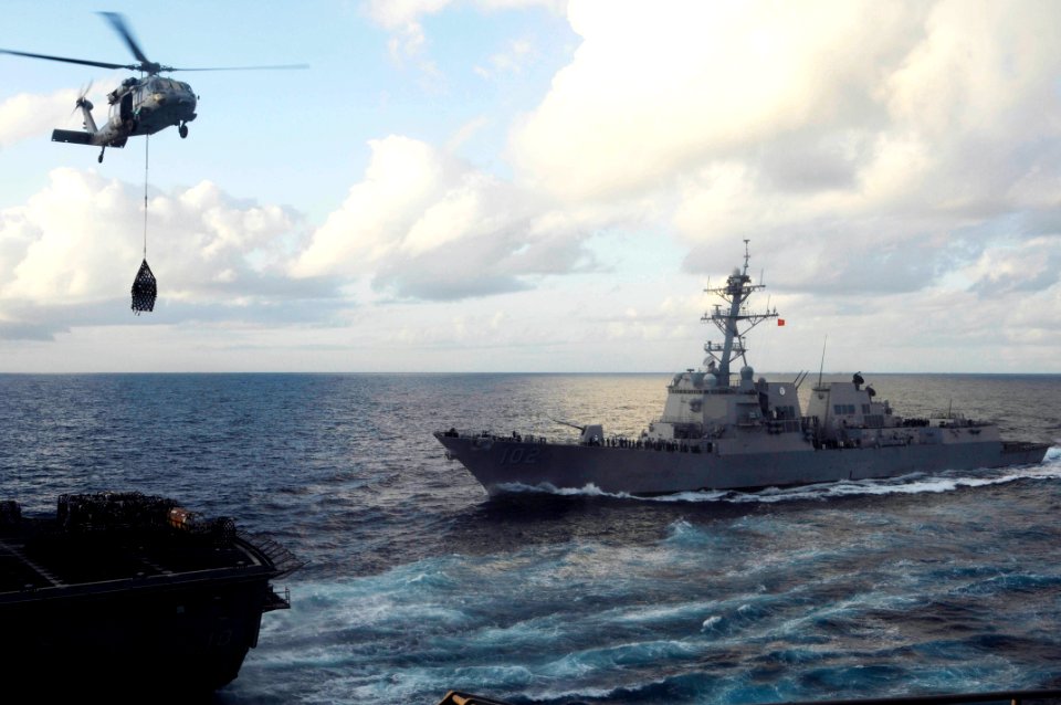US Navy 100225-N-3038W-352 An MH-60S Sea Hawk helicopter transports supplies from USNS Bridge (T-AOE 10)