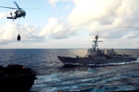 US Navy 100225-N-3038W-352 An MH-60S Sea Hawk helicopter transports supplies from USNS Bridge (T-AOE 10)