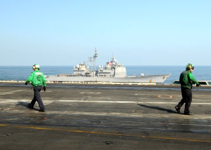 US Navy 100228-N-4236E-016 The guided-missile cruiser USS Hue City (CG 66) transits alongside the aircraft carrier USS Dwight D. Eisenhower (CVN 69)