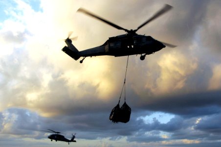 US Navy 100225-N-3038W-141 Two MH-60S Sea Hawk helicopters conduct a vertical replenishment at sea between USS Nimitz (CVN 68) and USNS Bridge (T-AOE 10)