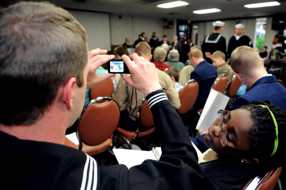 US Navy 100227-N-5328N-749 Information Systems Technician Seaman Apprentice Cameron Evans, a student at the Center for Information Dominance (CID) Corry Station, takes a photo during the 50th graduating class of Saturday Schola