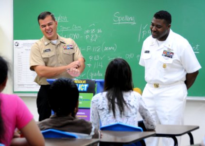 US Navy 100227-N-1906L-001 Information Systems Technician 1st Class Christopher Castillo and Senior Chief Information Systems Technician Steven Dupree complete the Saturday Scholars tutoring program at Vicente S.A. Benavente Mi photo
