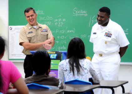 US Navy 100227-N-1906L-001 Information Systems Technician 1st Class Christopher Castillo and Senior Chief Information Systems Technician Steven Dupree complete the Saturday Scholars tutoring program at Vicente S.A. Benavente Mi