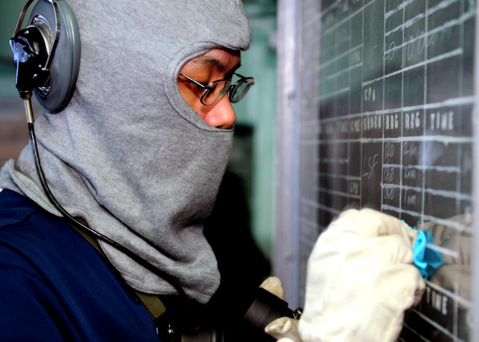 US Navy 100301-N-5538K-046 Operations Specialist Seaman Apprentice Ivan C. Valeriano maintains the status board on the bridge of USS Denver (LPD 9)
