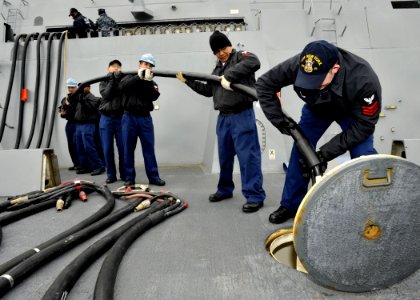 US Navy 100302-N-2147L-003 Sailors remove a shore power cable aboard SS New York (LPD 21)