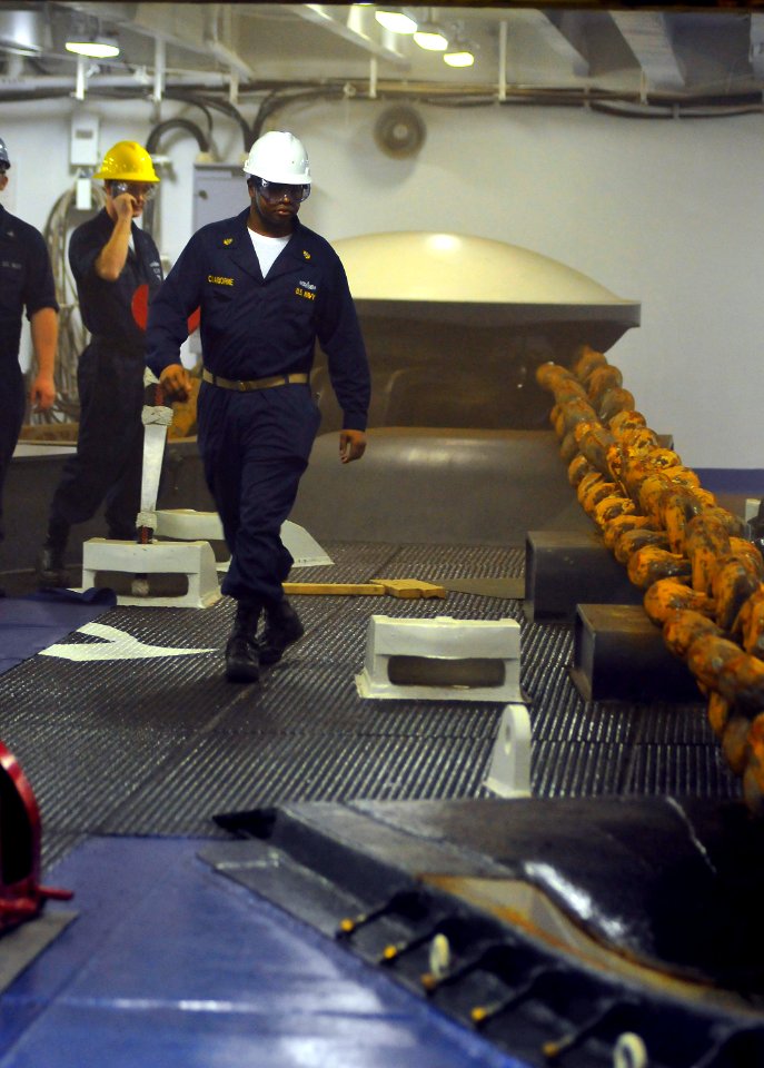 US Navy 100226-N-8878B-004 Chief Boatswain's Mate Sorrells Claiborne, from Columbus, Ga., watches as the anchor is dropped off the coast of Rio de Janeiro, Brazil