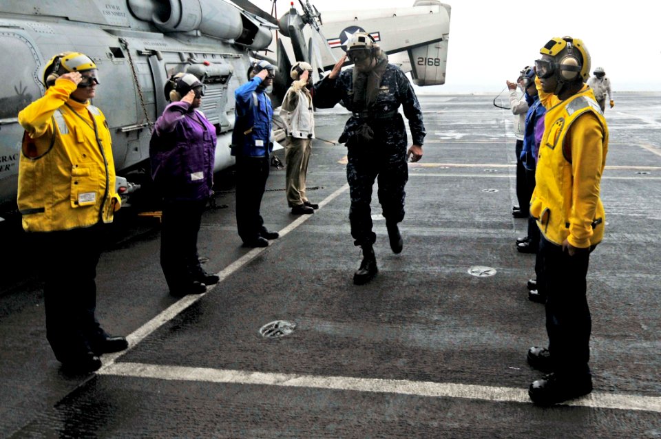 US Navy 100302-N-3038W-118 Rainbow side boys render honors to Rear Adm. Robert P. Girrier aboard the aircraft carrier USS Nimitz (CVN 68)