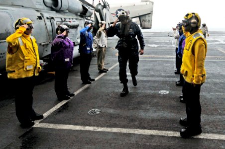 US Navy 100302-N-3038W-118 Rainbow side boys render honors to Rear Adm. Robert P. Girrier aboard the aircraft carrier USS Nimitz (CVN 68)