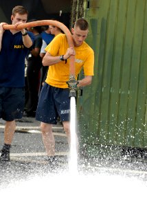 US Navy 100302-N-2000D-023 Seaman Shane Bartels conducts an agricultural wash down aboard the amphibious dock landing ship USS Carter Hall (LSD 50)