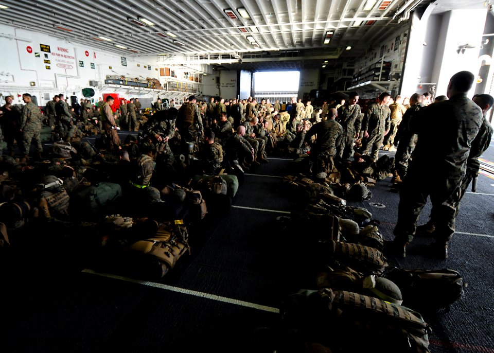 US Navy 100302-N-7948R-651 Marines assigned to the 15th Marine Expeditionary Unit (15th MEU) wait to disembark in the hangar bay aboard the amphibious assault ship USS Peleliu (LHA 5)