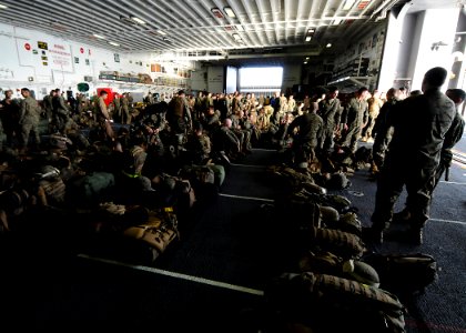 US Navy 100302-N-7948R-651 Marines assigned to the 15th Marine Expeditionary Unit (15th MEU) wait to disembark in the hangar bay aboard the amphibious assault ship USS Peleliu (LHA 5)