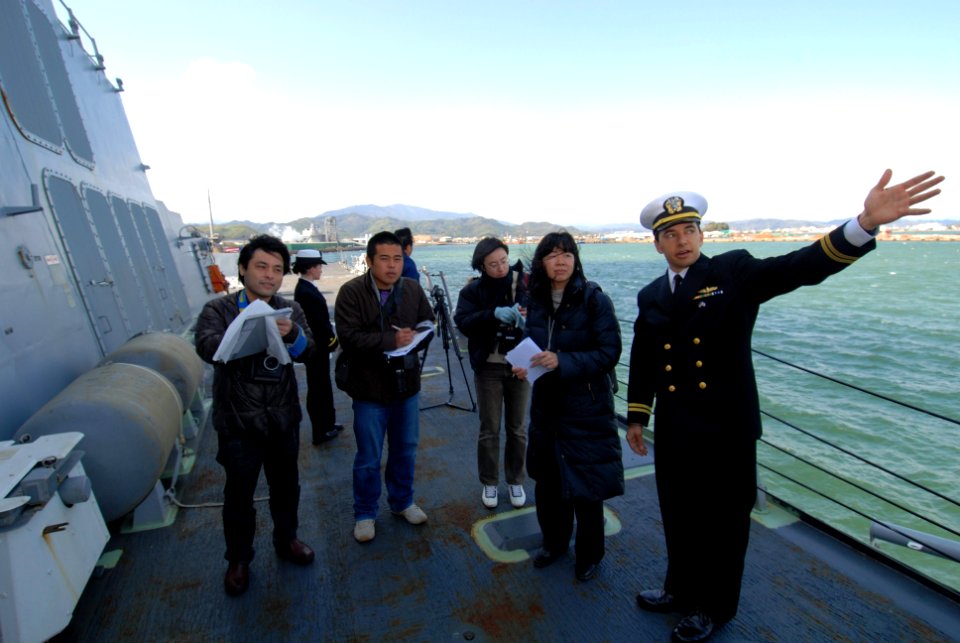 US Navy 100228-N-3283P-078 Lt. Jesse Maynor chief engineer aboard the guided-missile destroyer USS Pinckney (DDG 91), explains the ship's capabilities to members of the Japanese media during a tour of the ship