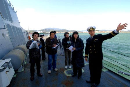 US Navy 100228-N-3283P-078 Lt. Jesse Maynor chief engineer aboard the guided-missile destroyer USS Pinckney (DDG 91), explains the ship's capabilities to members of the Japanese media during a tour of the ship