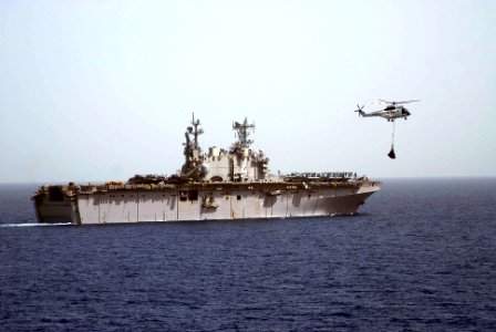 US Navy 100228-N-3358S-063 The amphibious assault ship USS Nassau (LHA 4) conducts a vertical replenishment with the Military Sealift Command dry cargo and ammunition ship USNS Robert E. Peary (T-AKE 5)