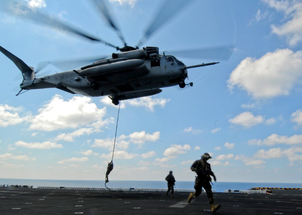 US Navy 100228-N-9950J-183 Marines assigned to the 31st Marine Expeditionary Unit (31st MEU) fast rope from a CH-53E Sea Stallion helicopter