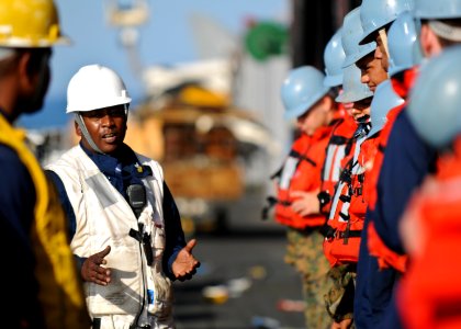 US Navy 100302-N-9950J-025 Boatswain's Mate 1st Class Andre Jackson delivers a safety brief aboard the forward-deployed amphibious assault ship USS Essex (LHD 2) before an underway