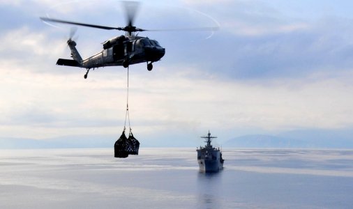 US Navy 100228-N-9740S-016 An MH-60S Sea Hawk helicopter from Helicopter Sea Combat Squadron (HSC) 22 delivers pallets of supplies to the multi-purpose amphibious assault ship USS Bataan (LHD 5) photo