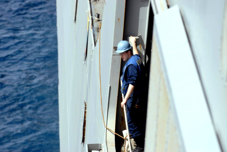 US Navy 100228-N-3358S-055 A Sailor aboard the amphibious transport dock ship USS Mesa Verde (LPD 19) watches as the Military Sealift Command dry cargo and ammunition ship USNS Robert E. Peary (T-AKE 5) moves alongside