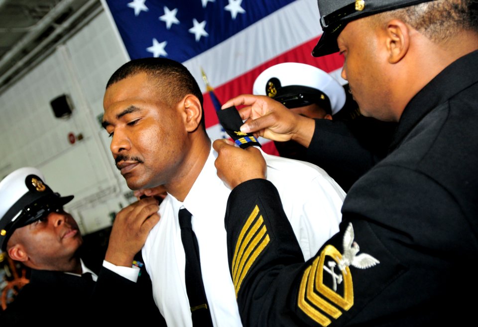 US Navy 100301-N-3595W-001 Chief Culinary Specialist Phillip Davis is commissioned to Chief Warrant Officer during a ceremony aboard the Nimitz-class aircraft carrier USS Dwight D. Eisenhower (CVN 69)