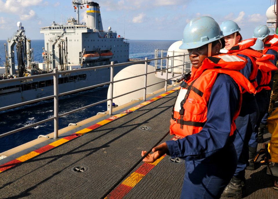 US Navy 100302-N-9950J-163 Seaman Niketa Hopson, from Detroit, steadies the phone and distance line aboard the forward-deployed amphibious assault ship USS Essex (LHD 2)