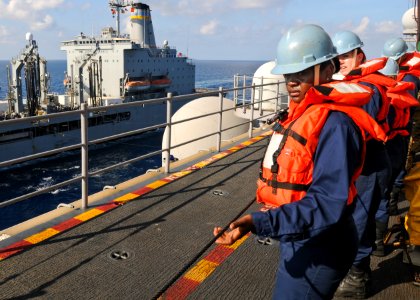 US Navy 100302-N-9950J-163 Seaman Niketa Hopson, from Detroit, steadies the phone and distance line aboard the forward-deployed amphibious assault ship USS Essex (LHD 2)