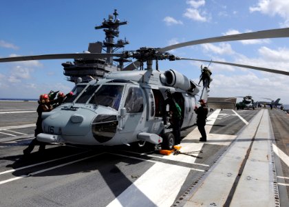 US Navy 100303-N-3885H-020 Crewmen prepare an MH-60S Sea Hawk helicopter for flight operations