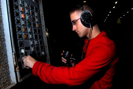 US Navy 100301-N-3327M-009 Aviation Ordnanceman Airman Brian Gilson operates a weapons elevator aboard the aircraft carrier USS Nimitz (CVN 68)