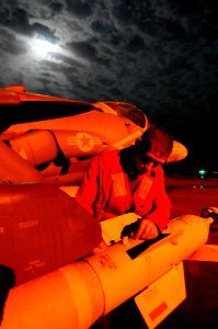 US Navy 100302-N-2735T-015 Aviation Ordnanceman 3rd Class Jonathan Flemming checks the ordnance mounted to an AV-8B Harrier aboard USS Nassau (LHA 4)