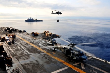 US Navy 100228-N-9740S-034 An MH-60S Sea Hawk helicopter from Helicopter Sea Combat Squadron (HSC) 22 delivers pallets of supplies to the multi-purpose amphibious assault ship USS Bataan (LHD 5)