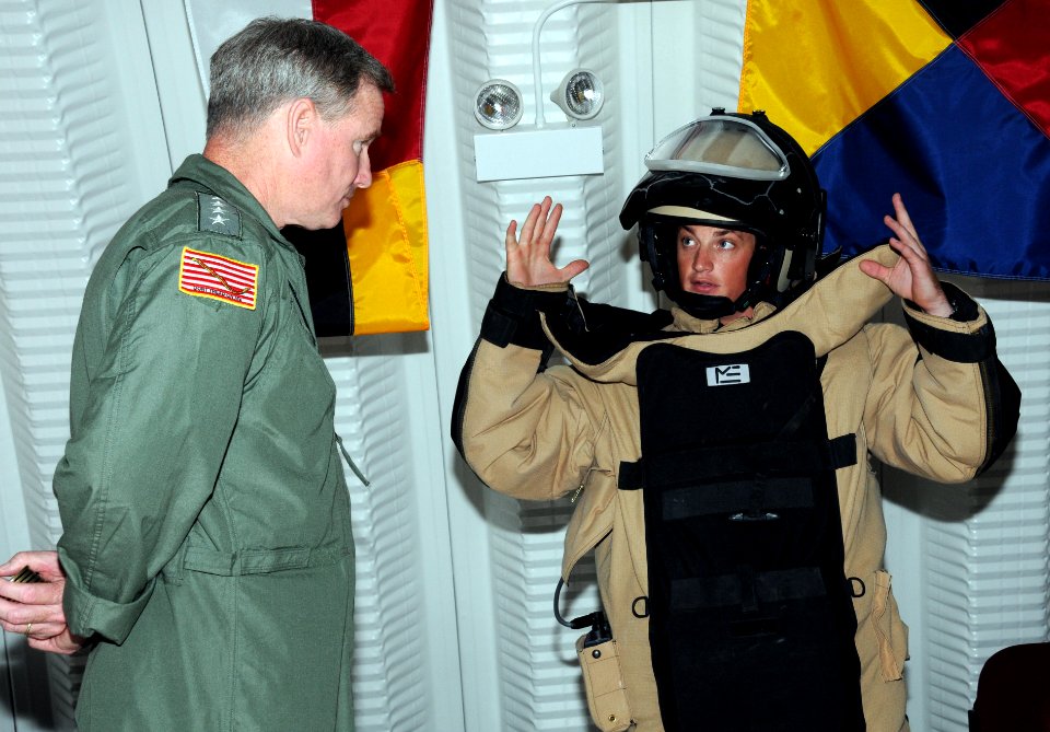 US Navy 100304-N-1906L-002 Adm. Patrick Walsh, left, commander of U.S. Pacific Fleet, listens to Explosive Ordnance Disposal Technician 2nd Class Daniel Smith, assigned to