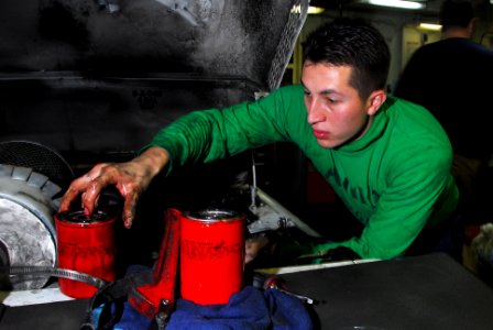 US Navy 100303-N-3327M-042 Aviation Support Equipment Technician Airman Antonio Escobedo performs maintenance on an aircraft tow tractor aboard the aircraft carrier USS Nimitz (CVN 68) photo