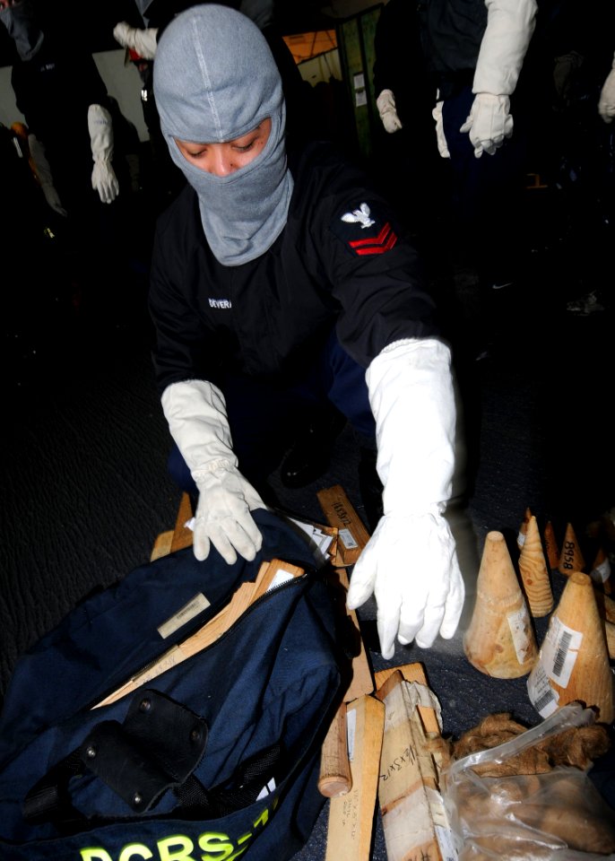 US Navy 100305-N-1062H-003 Aviation Machinist's Mate 2nd Class Jeff Devera prepares a shoring bag during a general quarters drill aboard the aircraft carrier USS George Washington (CVN 73)