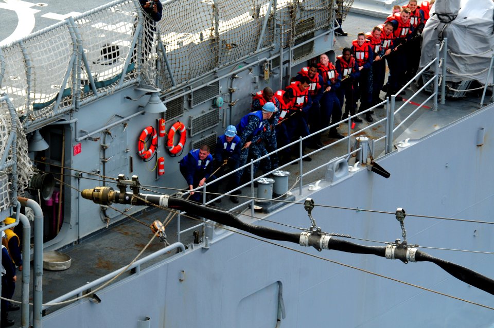 US Navy 100304-N-0808V-148 Sailors aboard the Ticonderoga-class cruiser USS Bunker Hill (CG 52) heave a line during a replenishment at sea with the aircraft carrier USS Carl Vinson (CVN 70)
