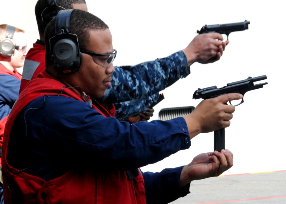 US Navy 100305-N-9793B-036 Aviation Ordnanceman Airman Corry E. Warner, assigned to the weapons department of the aircraft carrier USS George H.W. Bush (CVN 77), reloads an M-9 pistol