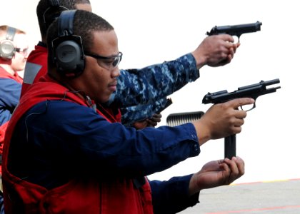 US Navy 100305-N-9793B-036 Aviation Ordnanceman Airman Corry E. Warner, assigned to the weapons department of the aircraft carrier USS George H.W. Bush (CVN 77), reloads an M-9 pistol