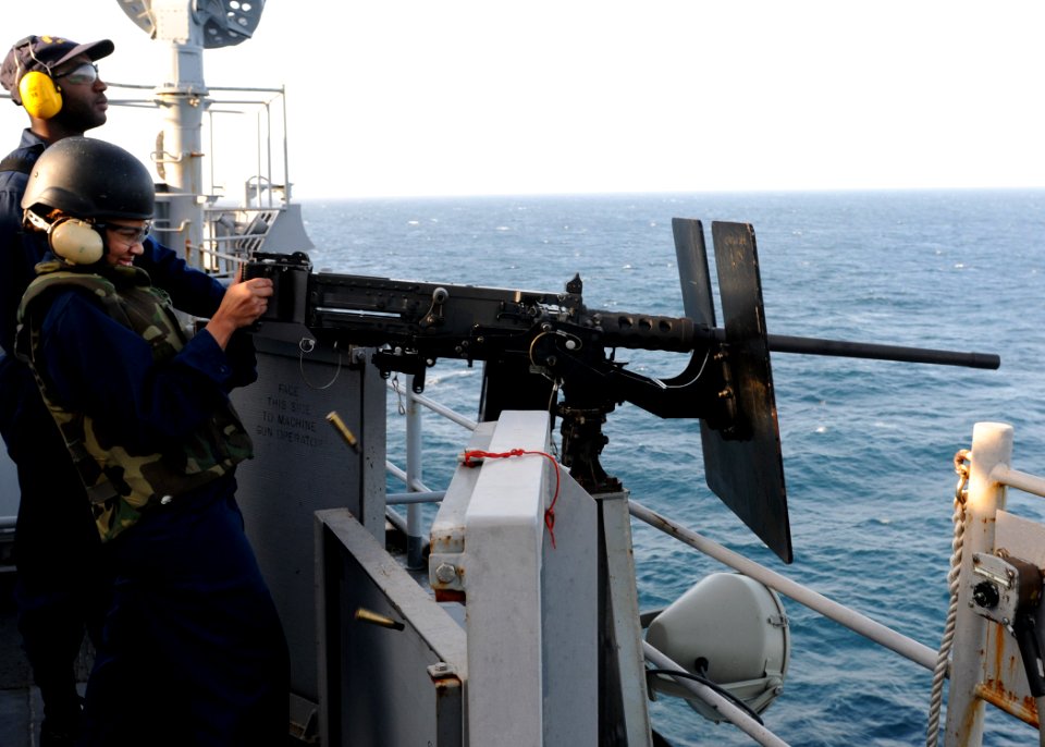 US Navy 100303-N-6676S-017 Culinary Specialist 2nd Class Jacqueline Mitchell, from Crystal Springs, Miss., fires a .50-caliber Browning machine gun during a live-fire training exercise