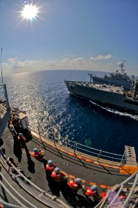 US Navy 100302-N-9950J-329 Sailors and Marines assigned to the forward-deployed amphibious assault ship USS Essex (LHD 2) steady the phone and distance line during an underway replenishment