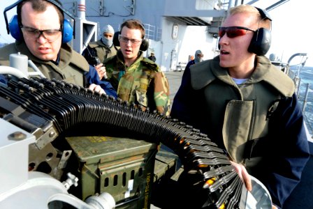 US Navy 100303-N-7280V-505 Gunner's Mates 3rd Class Brandon Field and William Bush load a Mk-38 25 mm machine gun system during a crew served weapons qualification shoot aboard the U.S. 7th Fleet command ship USS Blue Ridge (LC