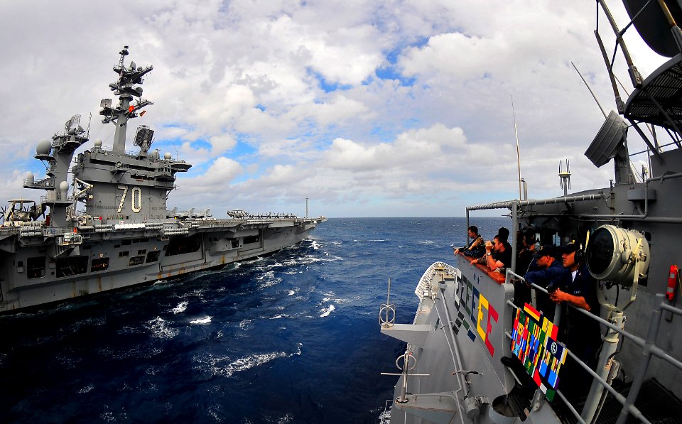 US Navy 100304-N-4774B-221 Sailors standing the bridge watch aboard the guided-missile cruiser USS Bunker Hill (CG 52) observe their approach towards the Nimitz-class aircraft carrier USS Carl Vinson (CVN 70)