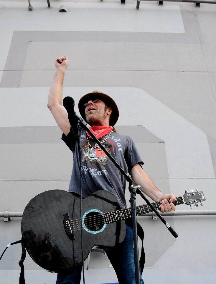 US Navy 100303-N-8655E-702 Big Kenny, a member of the country music duo Big and Rich, performs on the flight deck of the multipurpose amphibious assault ship USS Bataan (LHD 5)