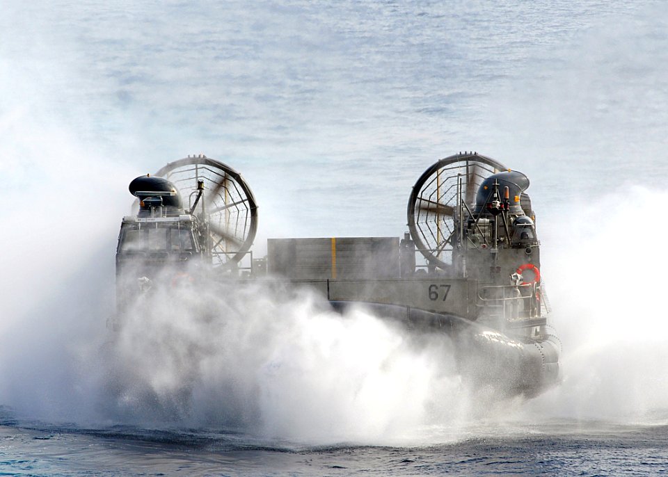 US Navy 100306-N-1082Z-057 Landing Craft Air Cushion (LCAC) 67, assigned to Assault Craft Unit (ACU) 4, transits toward the amphibious dock landing ship USS Ashland (LSD 48)
